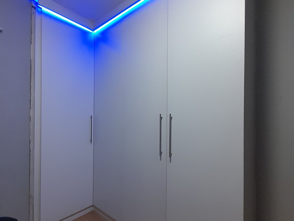 Corner cupboards finished with a concealed blue LED strip