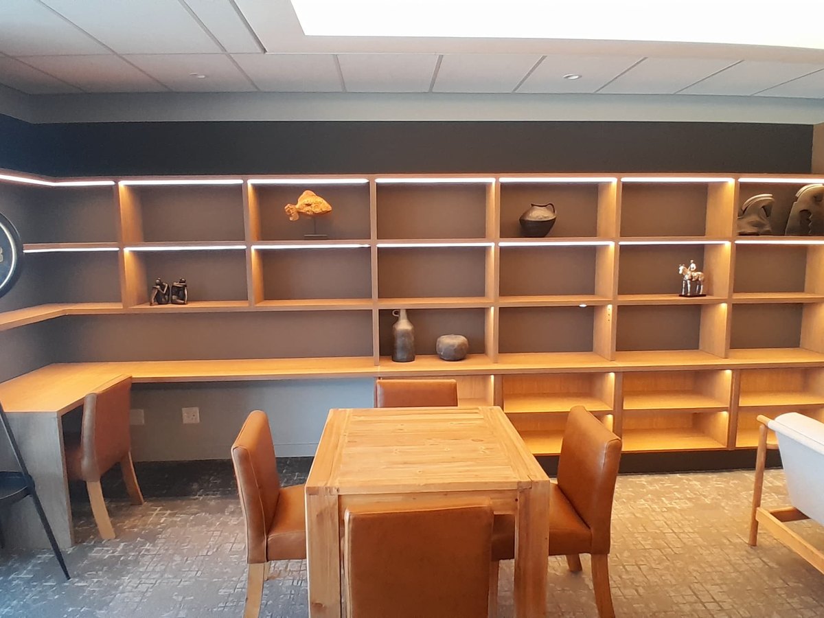 Full-height timber library shelving built for a commercial lounge