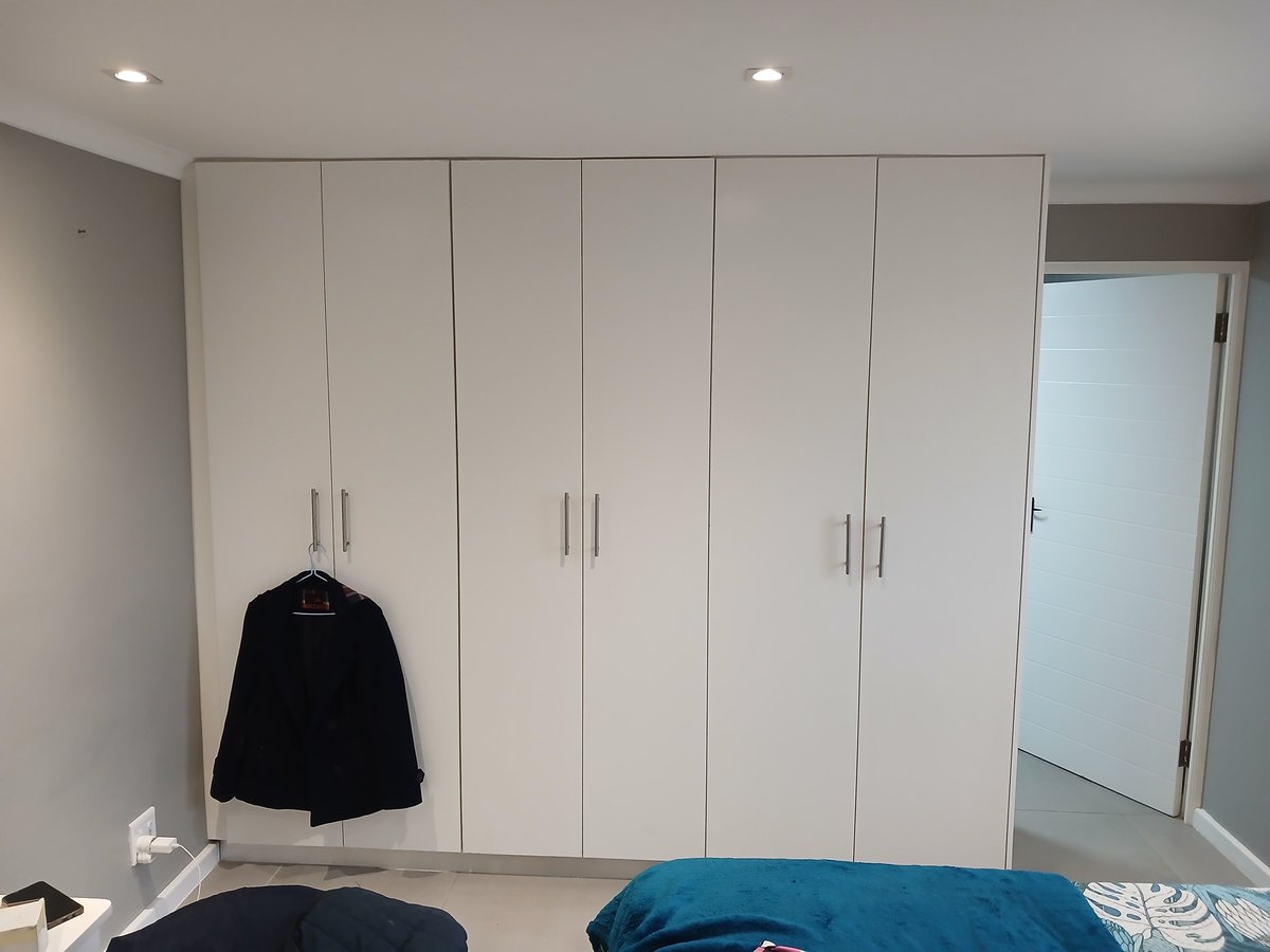 Full-height built-in bedroom wardrobe in white