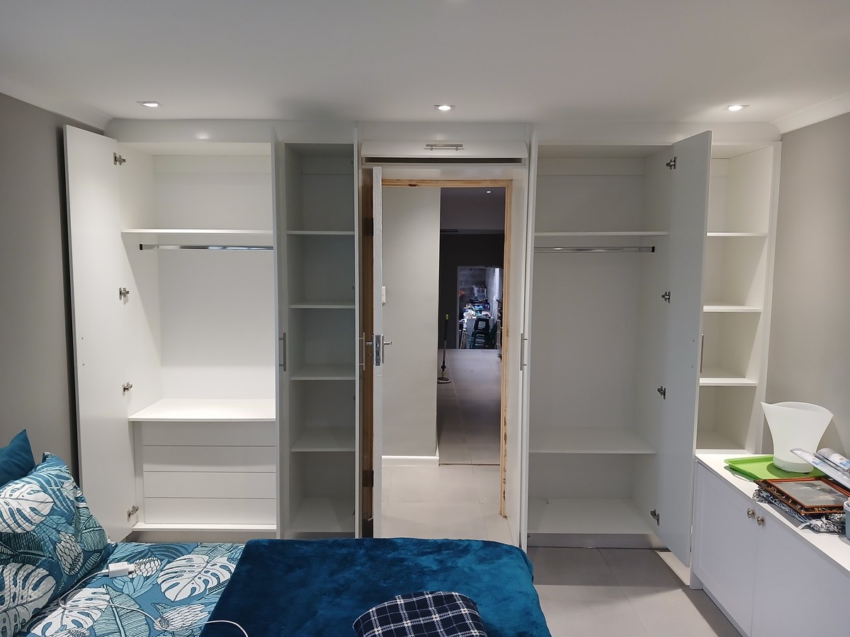 Walk-through wardrobe with open shelving and hanging space