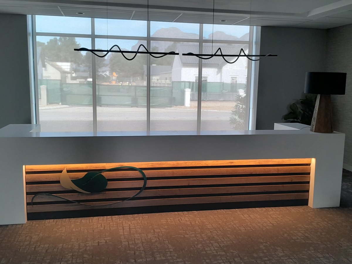 Reception desk with a slatted timber front