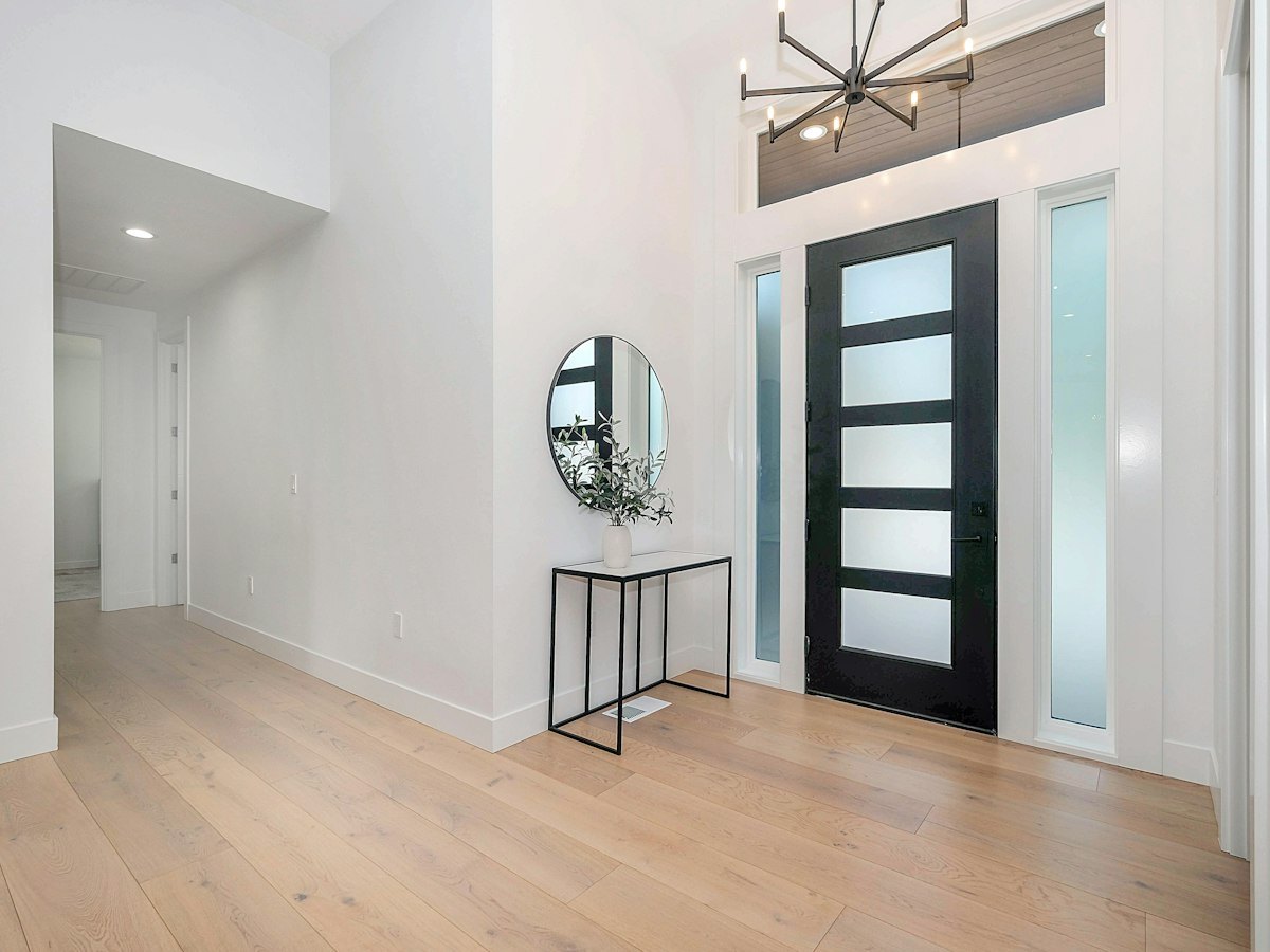 Hallway leading to a glazed timber door