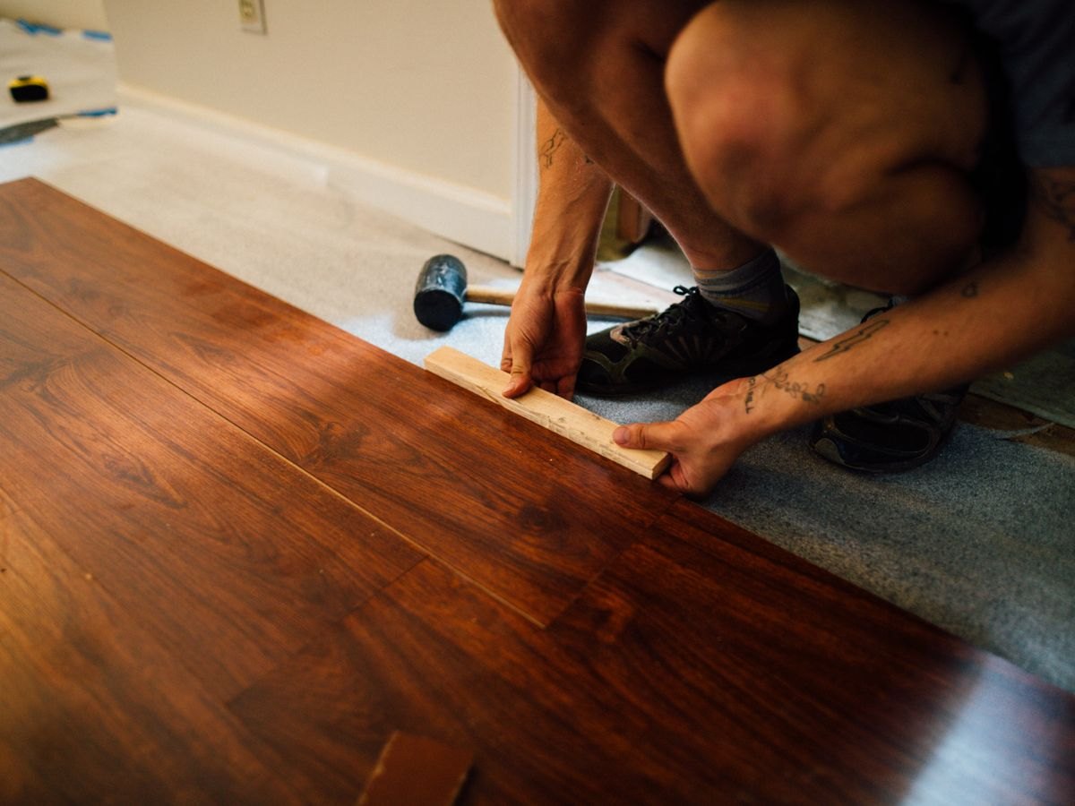 Laminated flooring being laid plank by plank