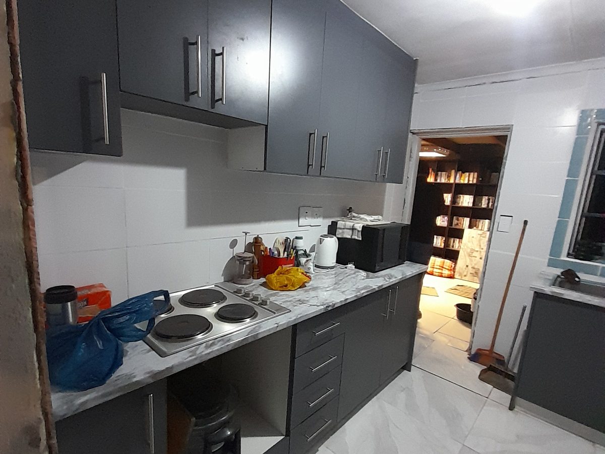 Dark stone kitchen counters under downlights