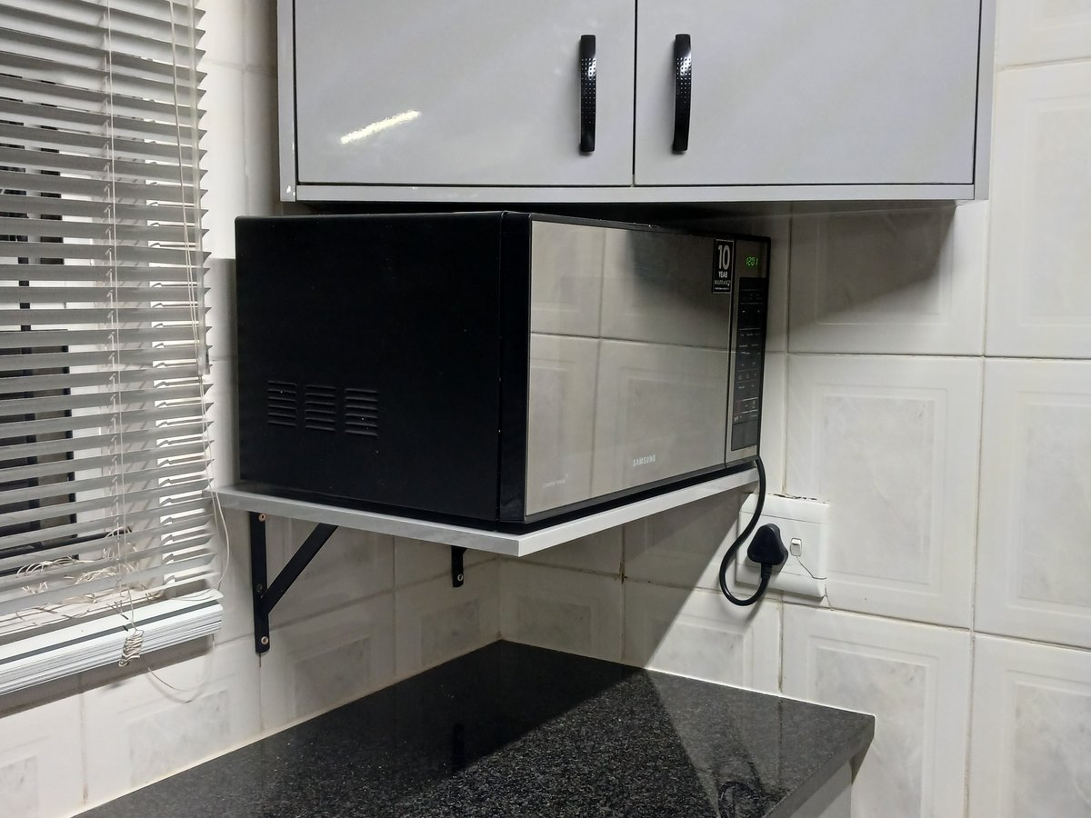 Fitted kitchen with granite tops and a tall fridge housing