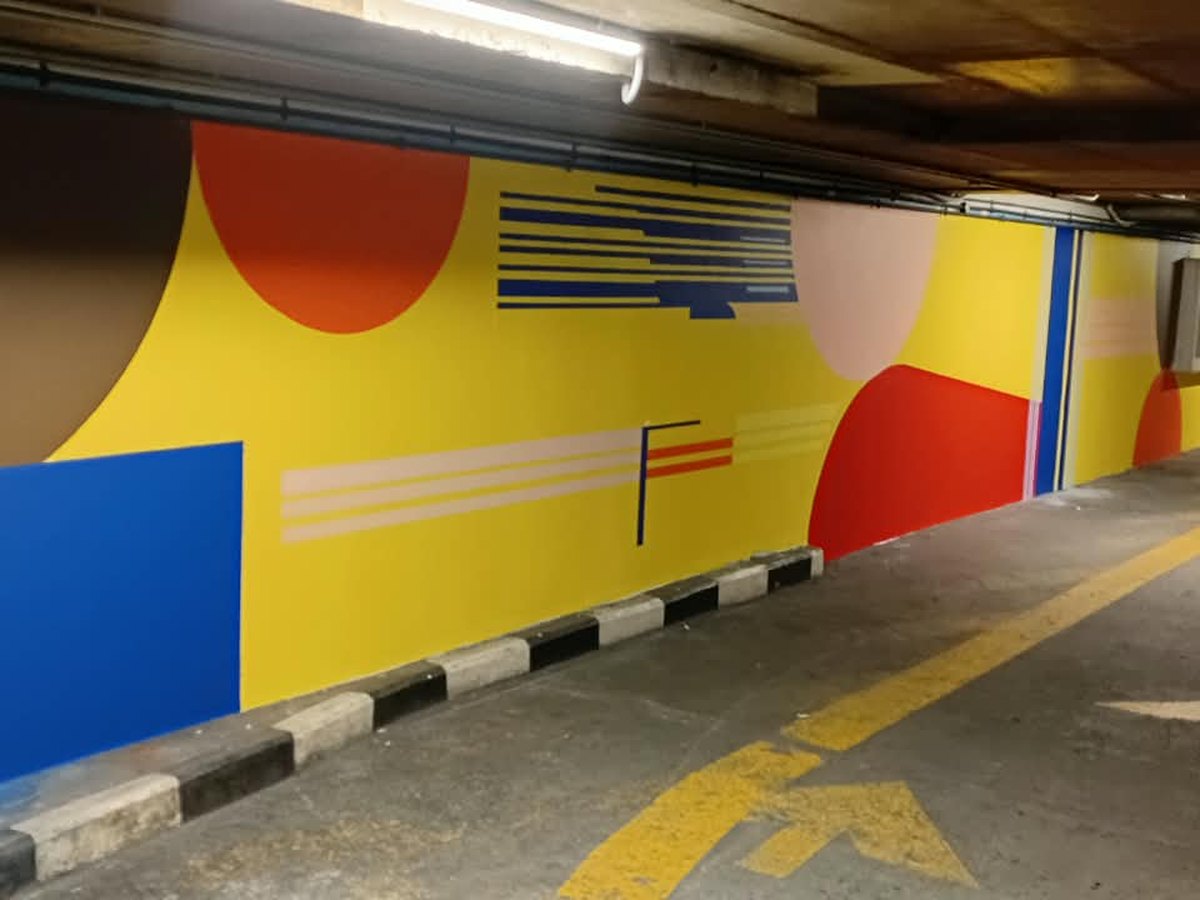 Large painted graphic mural in a parking garage